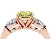 Fancy Yellow Three-Stone Oval Cut Diamond Ring Set in Rose gold with Pear Side Stones and Prong Setting
