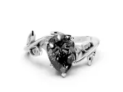 Fancy Black Pear Cut Diamond Solitaire Twist Engagement Ring Set in White gold with Pavé Leaf Accents