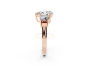 Pear Cut Diamond Three-Stone Ring Set in Rose gold with Round Accent Stones and Plain Band