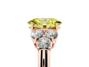 Fancy Yellow Oval Cut Diamond Cluster Ring Set in Rose gold with Round Accent Stones and Prong Setting on a Plain Band
