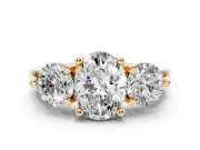 Oval Cut Diamond Three-Stone Ring Set in Yellow gold with Prong Setting and Classic Band