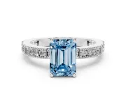 Fancy Blue Emerald Cut Diamond Solitaire Ring Set in White gold with Slim Pavé Band and Prong Setting