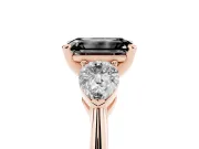 Fancy Black Three-Stone Emerald Cut Diamond Ring Set in Rose gold with Pear Side Stones and Prong Setting