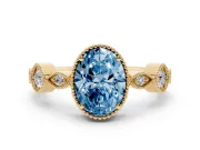 Fancy Blue Oval Cut Diamond Vintage-Inspired Milgrain Ring Set in Yellow gold with Marquise Stations of Round Accents