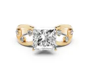 Princess Cut Diamond Solitaire Ring Set in Yellow gold with Side Stones on Criss-Cross Band and Prong Setting