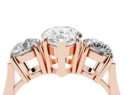 Pear Cut Diamond Three-Stone Ring Set in Rose gold with Round Accent Stones and Plain Band