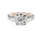 Round Cut Diamond Solitaire Set in Rose gold with Side Baguettes and Channel Set Band