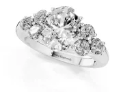 Oval Cut Diamond Cluster Ring Set in Silver with Round Accent Stones and Prong Setting on a Plain Band