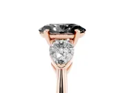 Fancy Black Three-Stone Oval Cut Diamond Ring Set in Rose gold with Pear Side Stones and Prong Setting