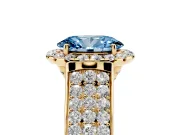 Fancy Blue Oval Cut Diamond Halo Ring Set in Yellow gold with Pavé Band and Raised Center Setting