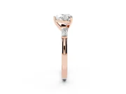Heart Cut Diamond Solitaire Ring Set in Rose gold with Tapered Baguette Side Stones and Prong Setting