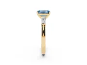 Fancy Blue Emerald Cut Diamond Solitaire Ring Set in Yellow gold with Tapered Baguette Side Stones and Prong Setting