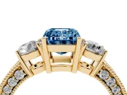 Fancy Blue Emerald Cut Diamond Three-Stone Ring Set in Yellow gold with Round Side Stones and Pavé Band