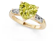 Fancy Yellow Heart Cut Diamond Solitaire Ring Set in Yellow gold with Tapered Baguette Side Stones and Prong Setting