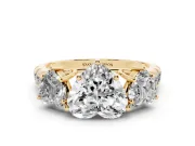 Heart Cut Diamond Three-Stone Ring Set in Yellow gold with Pavé Band