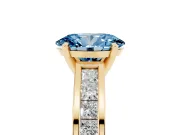 Fancy Blue Oval Cut Diamond Solitaire Ring Set in Yellow gold with Channel-Set Band and Prong Setting