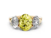 Fancy Yellow Oval Cut Diamond Three-Stone Ring Set in Yellow gold with Bold Center and Classic Band