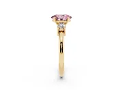 Fancy Pink Three-Stone Oval Cut Diamond Ring Set in Yellow gold with Prong Setting and Plain Band