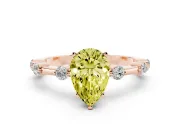 Fancy Yellow Pear Cut Diamond Solitaire Ring Set in Rose gold with Bezel Set Side Stones and Prong Setting