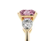 Fancy Pink Three-Stone Princess Cut Diamond Ring Set in Yellow gold with Pear Side Stones and Prong Setting