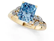 Fancy Blue Radiant Cut Diamond Solitaire Ring Set in Yellow gold with Marquise Twist Band and Prong Setting