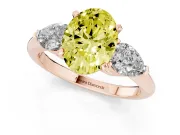 Fancy Yellow Three-Stone Oval Cut Diamond Ring Set in Rose gold with Pear Side Stones and Prong Setting