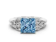 Fancy Blue Princess Cut Diamond Cluster Ring Set in Silver with Round Accent Stones and Prong Setting on a Plain Band