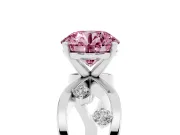 Fancy Pink Round Cut Diamond Solitaire Ring Set in Platinum with Side Stones on Criss-Cross Band and Prong Setting