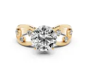 Round Cut Diamond Solitaire Ring Set in Yellow gold with Side Stones on Criss-Cross Band and Prong Setting