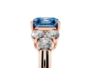 Fancy Blue Asscher Cut Diamond Cluster Ring Set in Rose gold with Round Accent Stones and Prong Setting on a Plain Band