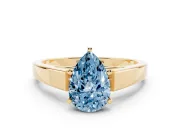 Fancy Blue Pear Cut Diamond Solitaire Engagement Ring Set in Yellow gold with Prong Setting and Tapered Band