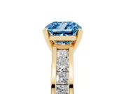 Fancy Blue Cushion Cut Diamond Solitaire Ring Set in Yellow gold with Channel-Set Band and Prong Setting