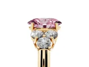 Fancy Pink Oval Cut Diamond Cluster Ring Set in Yellow gold with Round Accent Stones and Prong Setting on a Plain Band