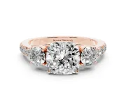 Cushion Cut Diamond Three-Stone Ring Set in Rose gold with Round Side Stones and Delicate Pavé Band