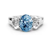 Fancy Blue Three-Stone Oval Cut Diamond Ring Set in Platinum with Matching Prong Settings and Plain Band