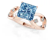 Fancy Blue Princess Cut Diamond Solitaire Ring Set in Rose gold with Side Stones on Criss-Cross Band and Prong Setting