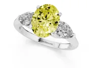 Fancy Yellow Three-Stone Oval Cut Diamond Ring Set in Platinum with Pear Side Stones and Prong Setting