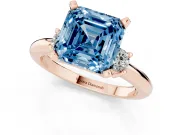 Fancy Blue Three-Stone Asscher Cut Diamond Ring Set in Rose gold with Prong Setting and Plain Band