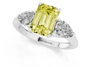 Fancy Yellow Three-Stone Emerald Cut Diamond Ring Set in White gold with Pear Side Stones and Prong Setting