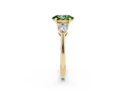 Fancy Green Three-Stone Oval Cut Diamond Ring Set in Yellow gold with Pear Side Stones and Prong Setting