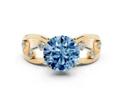 Fancy Blue Round Cut Diamond Solitaire Ring Set in Yellow gold with Side Stones on Criss-Cross Band and Prong Setting