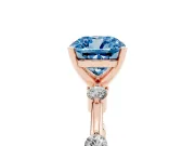 Fancy Blue Cushion Cut Diamond Solitaire Ring Set in Rose gold with Bezel Set Side Stones and Prong Setting