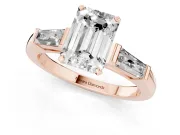 Emerald Cut Diamond Solitaire Ring Set in Rose gold with Tapered Baguette Side Stones and Prong Setting