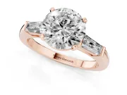 Round Cut Diamond Solitaire Ring Set in Rose gold with Tapered Baguette Side Stones and Prong Setting