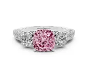Fancy Pink Cushion Cut Diamond Three-Stone Ring Set in Platinum with Round Side Stones and Pavé Band