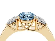 Fancy Blue Three-Stone Oval Cut Diamond Ring Set in Yellow gold with Matching Prong Settings and Plain Band
