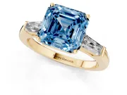 Fancy Blue Asscher Cut Diamond Solitaire Ring Set in Yellow gold with Tapered Baguette Side Stones and Prong Setting
