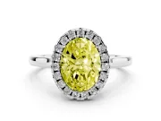 Fancy Yellow Oval Cut Halo Round Diamond Solitaire Ring Set in Platinum with Pavé Band and Prong Setting