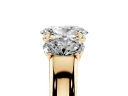 Three-Stone Oval Cut Diamond Ring Set in Yellow gold with Matching Prong Settings and Plain Band