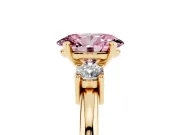 Fancy Pink Three-Stone Oval Cut Diamond Ring Set in Yellow gold with Prong Setting and Plain Band